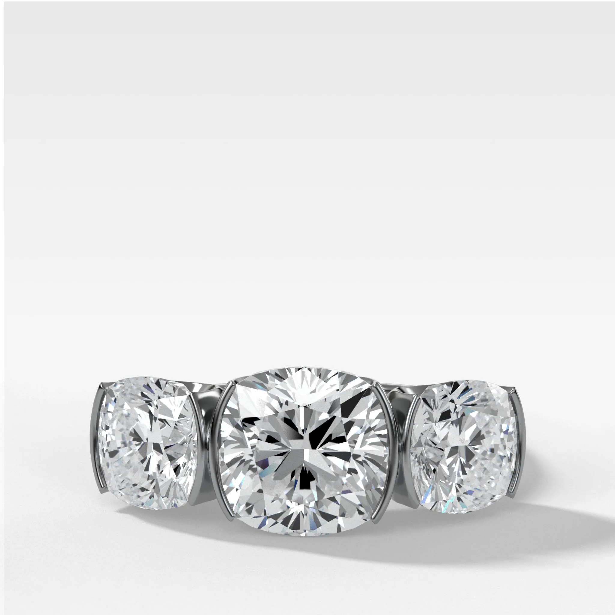 Half Bezel Triad Engagement Ring With Cushion Cut Diamonds