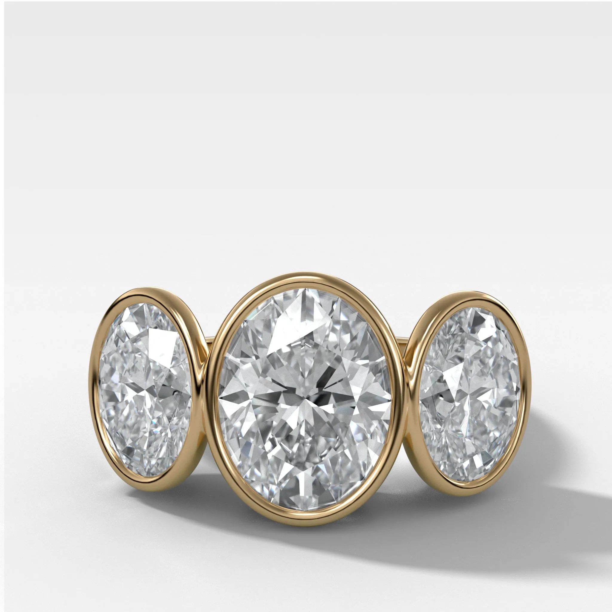 Penumbra Bezel Triad Engagement Ring With Oval Cut Diamonds