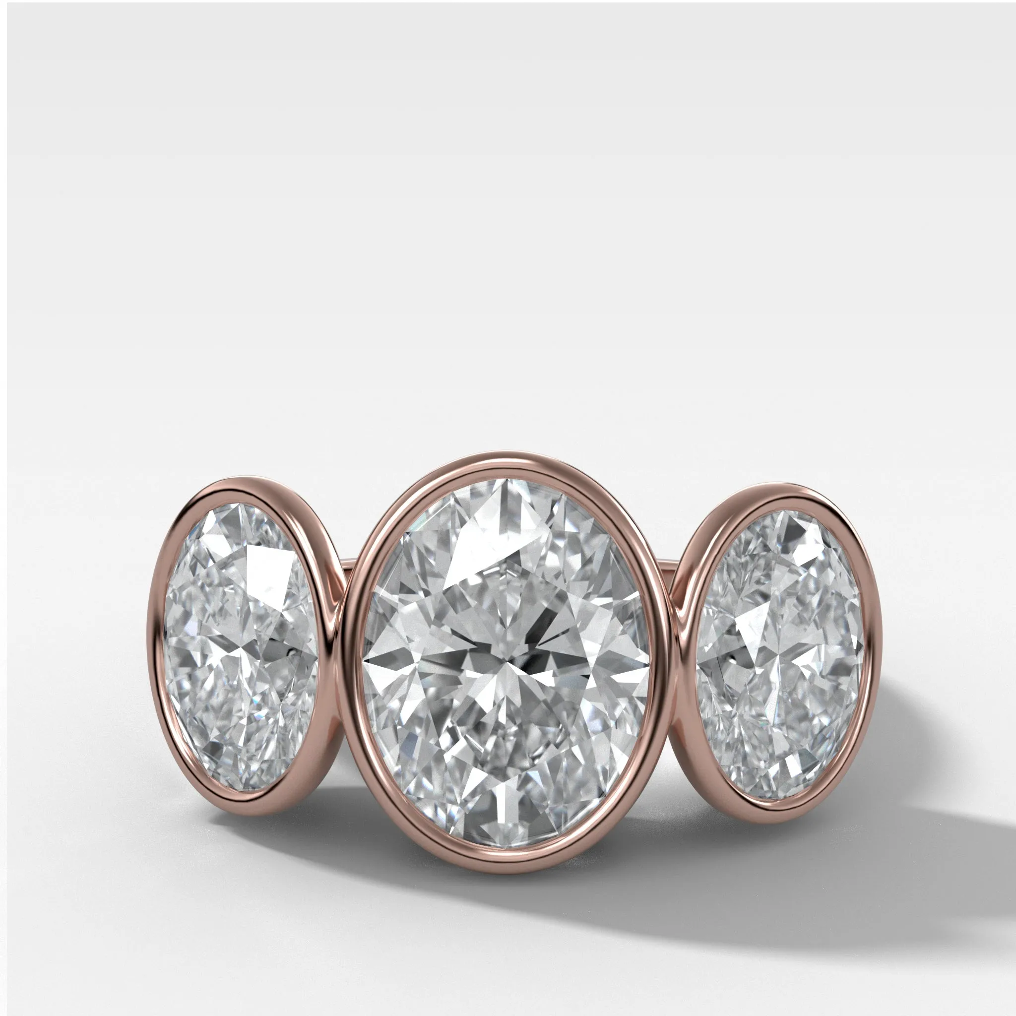Penumbra Bezel Triad Engagement Ring With Oval Cut Diamonds